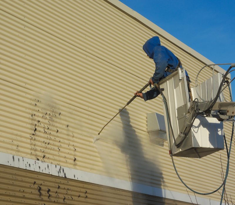 Professional commercial pressure washing of a metal building exterior